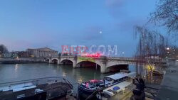 Paris: Greenpeace activists light smoke bombs and hang banners supporting the farmers - AFP