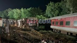 Rescuers clear train tracks in the aftermath of derailment - AFP