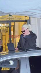 Singer/actress Lady Gaga plays fans her new music from an iPad outside of her hotel in Paris