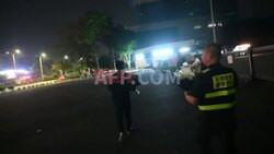 Workers remove flowers from memorial for China car ramming victims - AFP