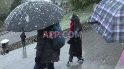 Tourists and Parisians stroll through Montmartre in the snow - AFP