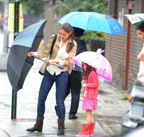 Katie Holmes takes Suri for a stroll in the rain