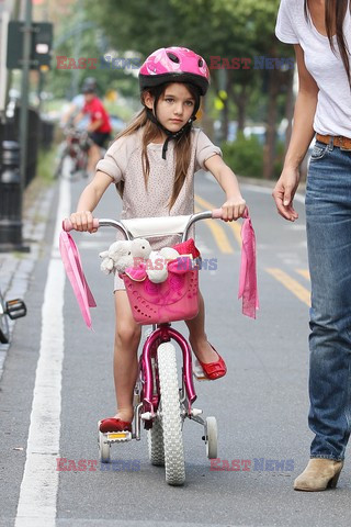 Katie Holmes teaches Suri Cruise to ride her brand new bright pink bike