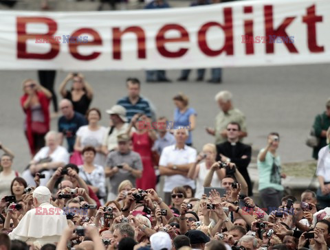 Pope mantle is blown by the wind as he reads his message during the weekly general audience