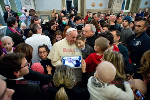 Pope Francis caresses a child as he arrives at the "Bambin Gesu'" children's hospital in Rome