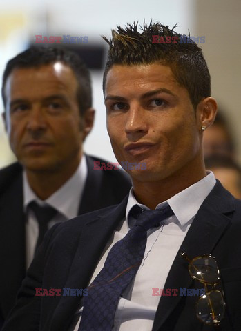 Cristiano Ronaldo smiles after signing the renewal of his contract 