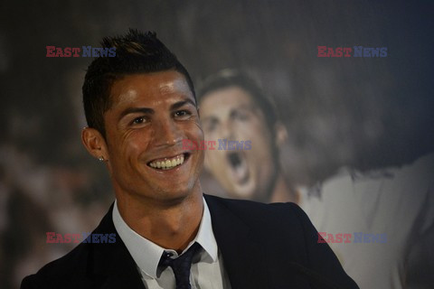 Cristiano Ronaldo smiles after signing the renewal of his contract 