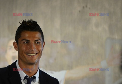 Cristiano Ronaldo smiles after signing the renewal of his contract 