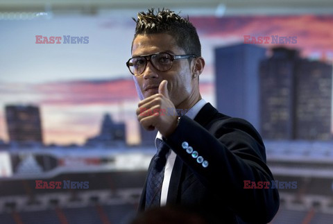 Cristiano Ronaldo smiles after signing the renewal of his contract 