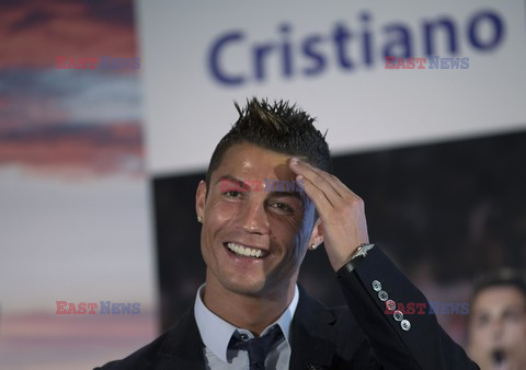 Cristiano Ronaldo smiles after signing the renewal of his contract 