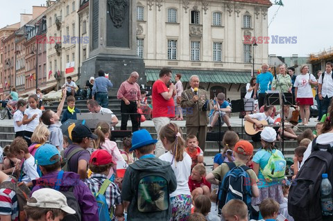 Dzieci i mlodzież oddają hołd pod pomnikiem Małego Powstańca