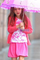 Katie Holmes takes Suri for a stroll in the rain