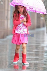 Katie Holmes takes Suri for a stroll in the rain