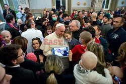 Pope Francis caresses a child as he arrives at the "Bambin Gesu'" children's hospital in Rome