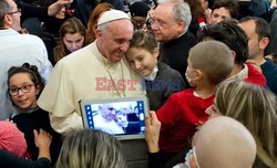 Pope Francis caresses a child as he arrives at the "Bambin Gesu'" children's hospital in Rome