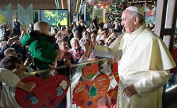 Pope Francis caresses a child as he arrives at the "Bambin Gesu'" children's hospital in Rome