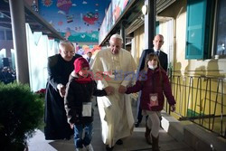 Pope Francis caresses a child as he arrives at the "Bambin Gesu'" children's hospital in Rome