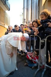 Pope Francis caresses a child as he arrives at the "Bambin Gesu'" children's hospital in Rome