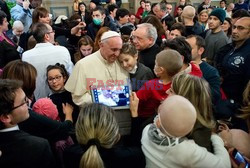 Pope Francis caresses a child as he arrives at the "Bambin Gesu'" children's hospital in Rome