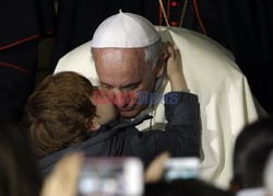 Pope Francis caresses a child as he arrives at the "Bambin Gesu'" children's hospital in Rome