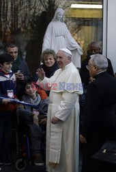 Pope Francis caresses a child as he arrives at the "Bambin Gesu'" children's hospital in Rome