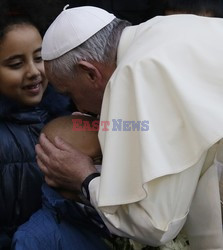 Pope Francis caresses a child as he arrives at the "Bambin Gesu'" children's hospital in Rome